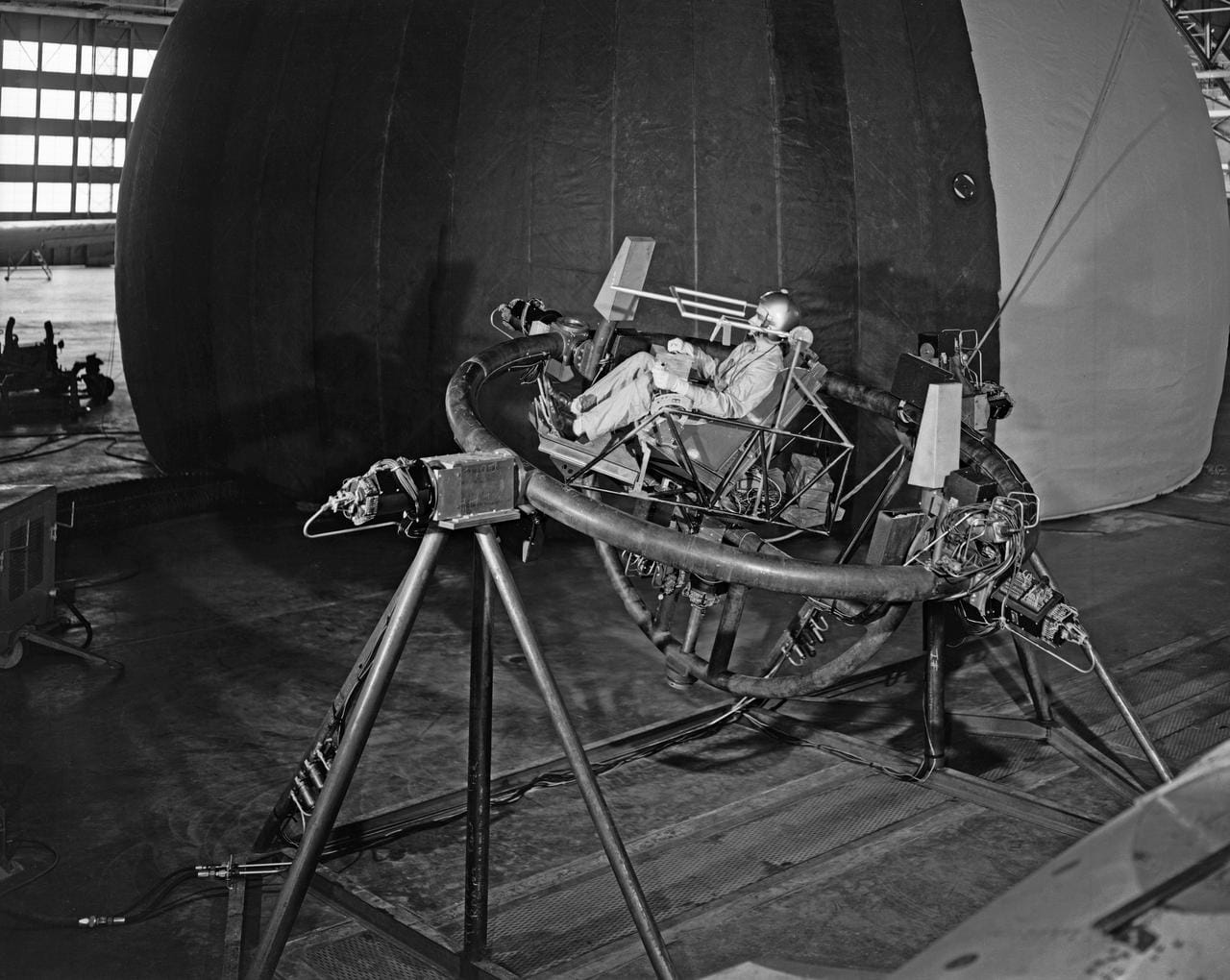 Man sits in a large gyroscope as part of NASA testing in the 1960s